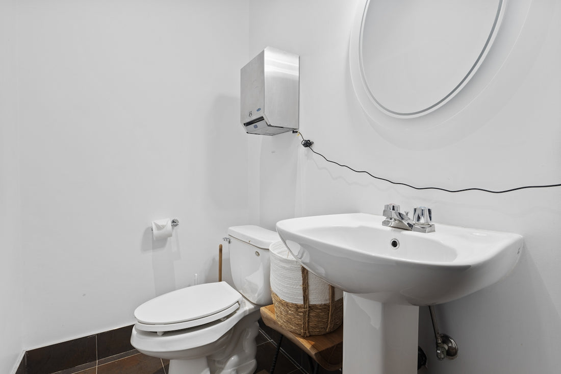 a bathroom with a sink toilet and mirror