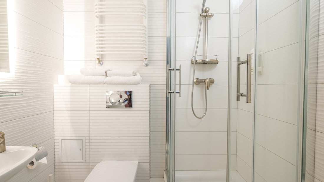 a bathroom with a shower unit and toilet