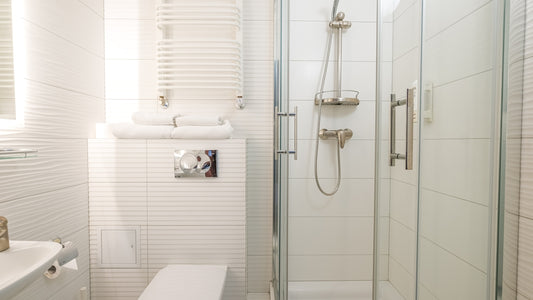 a bathroom with a shower unit and toilet