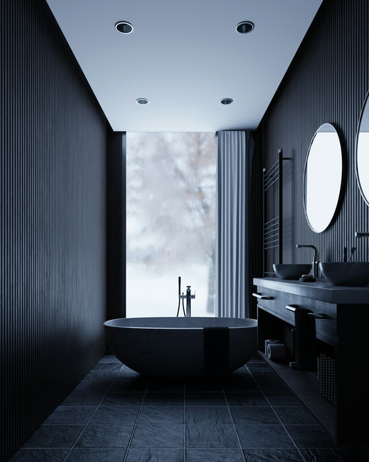 Modern dark bathroom with freestanding tub and double vanity.