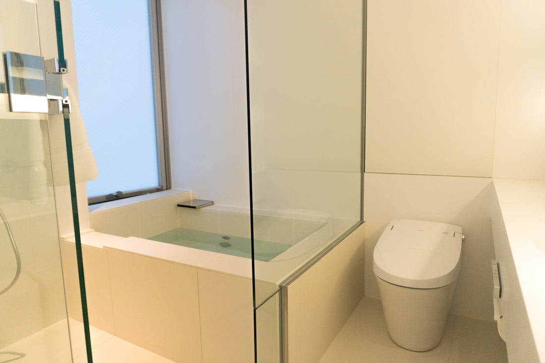 A bathroom with a glass shower and a toilet
