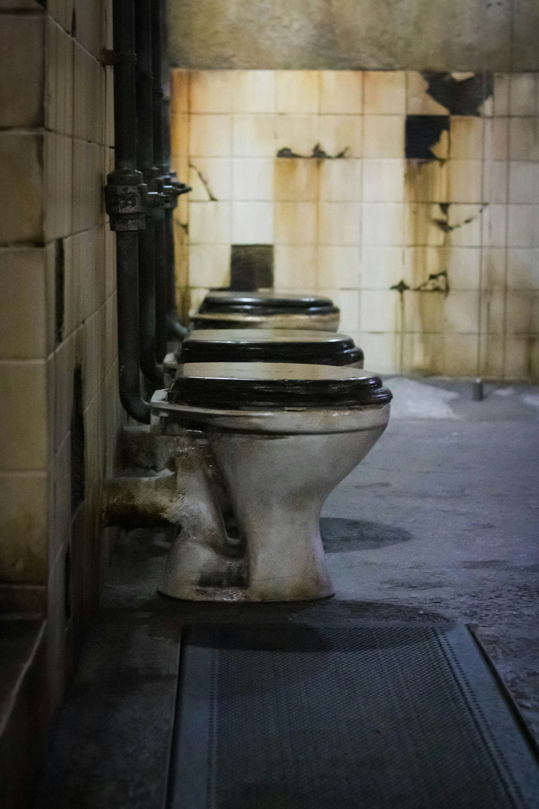 A row of toilets sitting next to each other in a bathroom