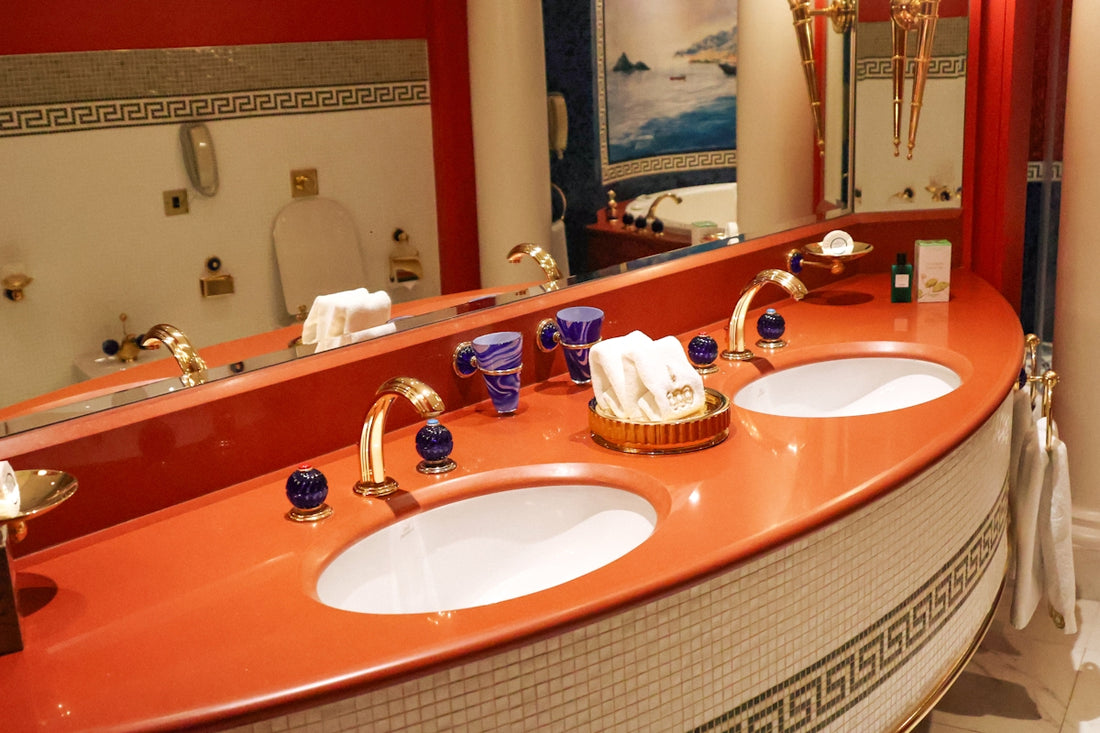 Luxurious bathroom with gold fixtures and double sinks.