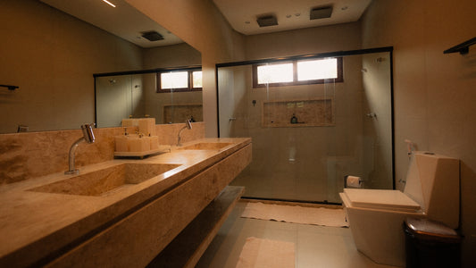 Modern bathroom with double vanity and glass shower.