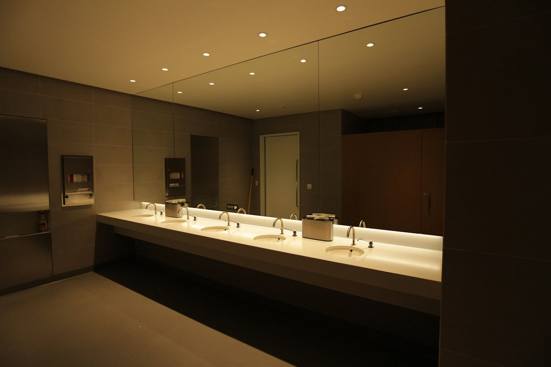 A modern public restroom with sinks and mirrors.