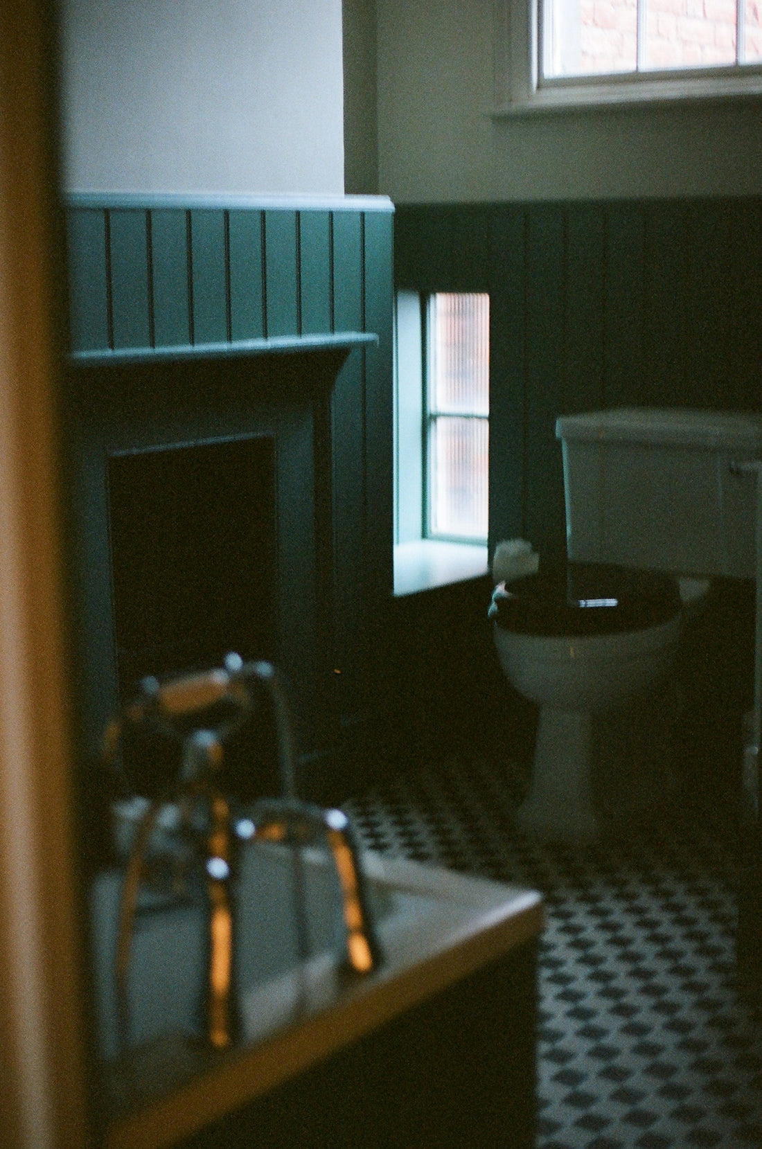 Dark bathroom with vintage fireplace and checkered floor