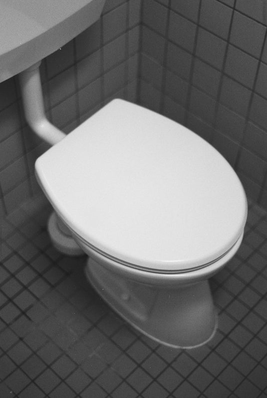 A white toilet in a tiled bathroom